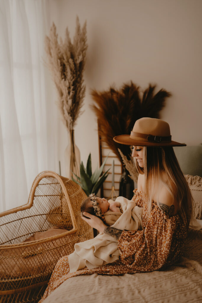 mom with baby in boho lifestyle setting with harrisburg pa newborn photographer